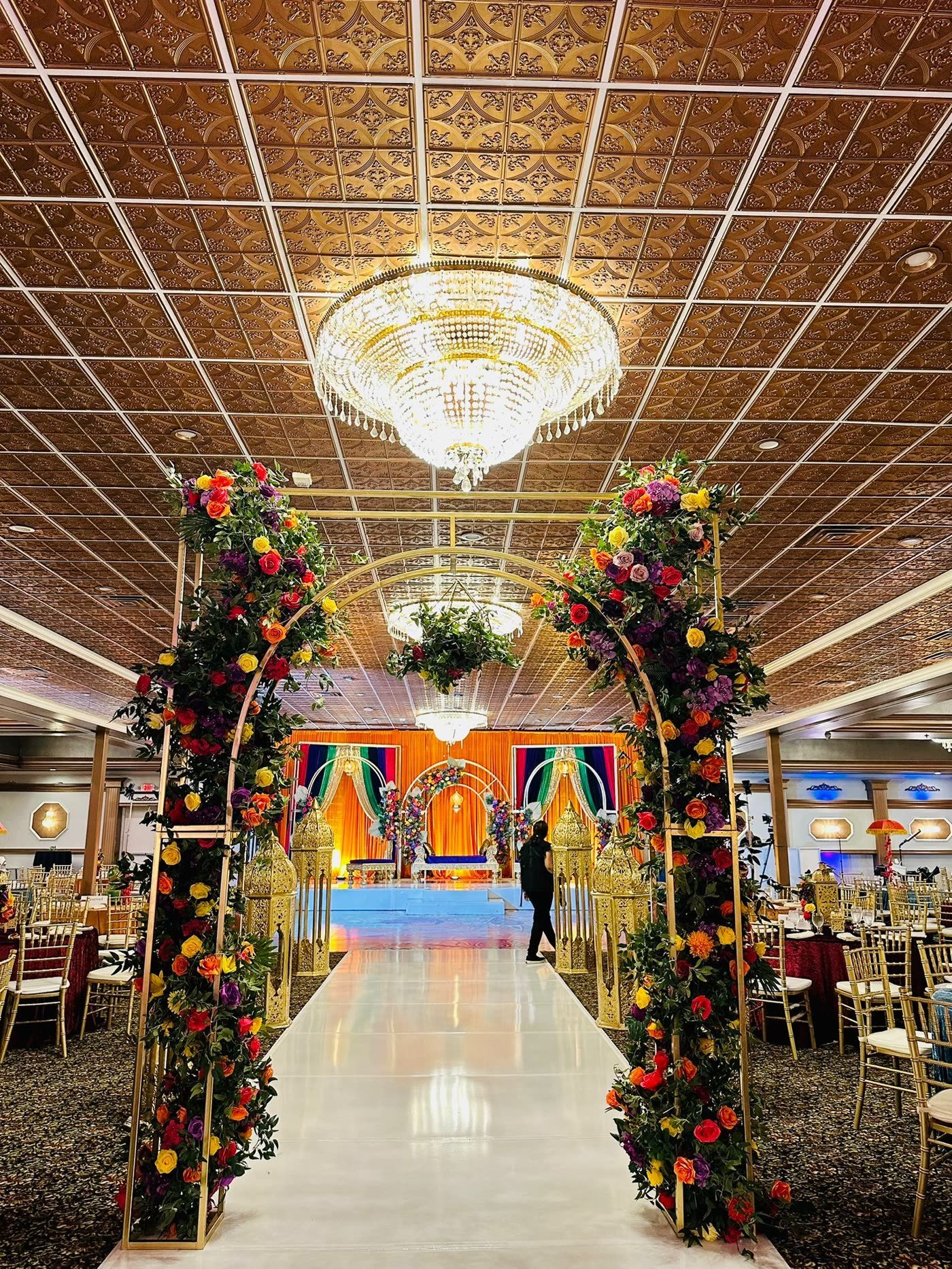 Colourful floral arches framing the stage