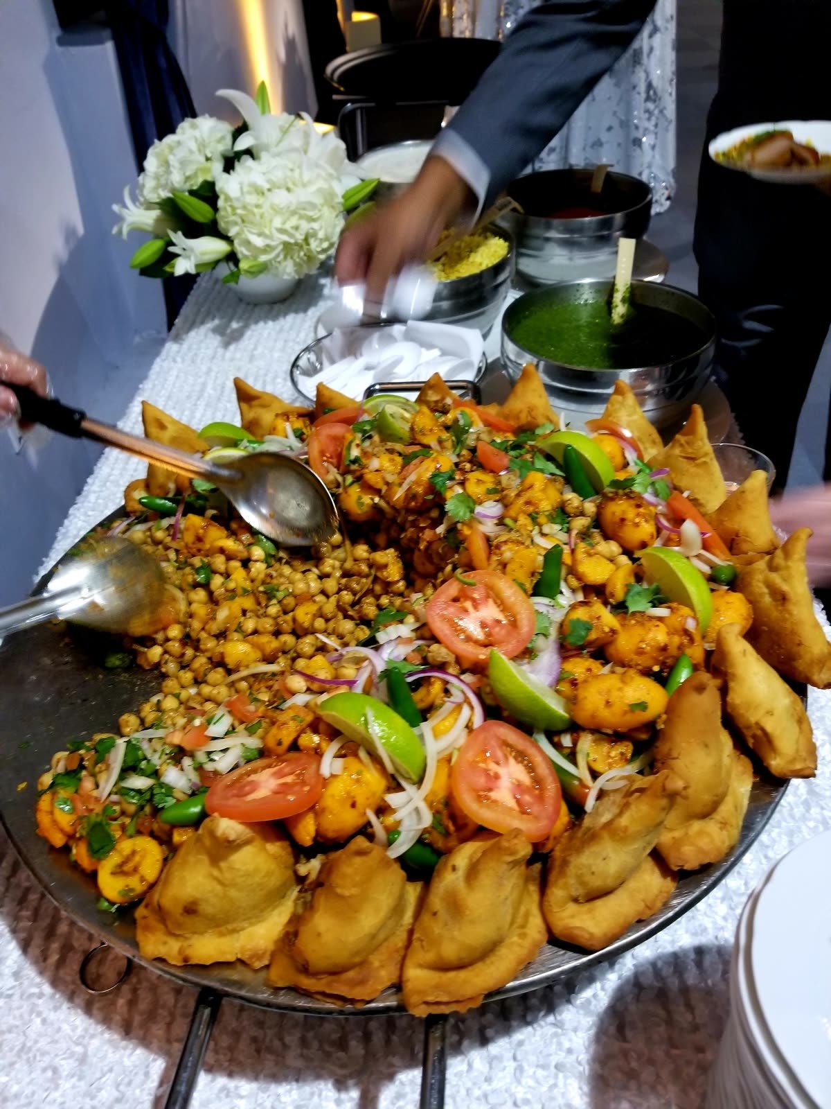 Samosa chaat with chickpeas, tomato and lime