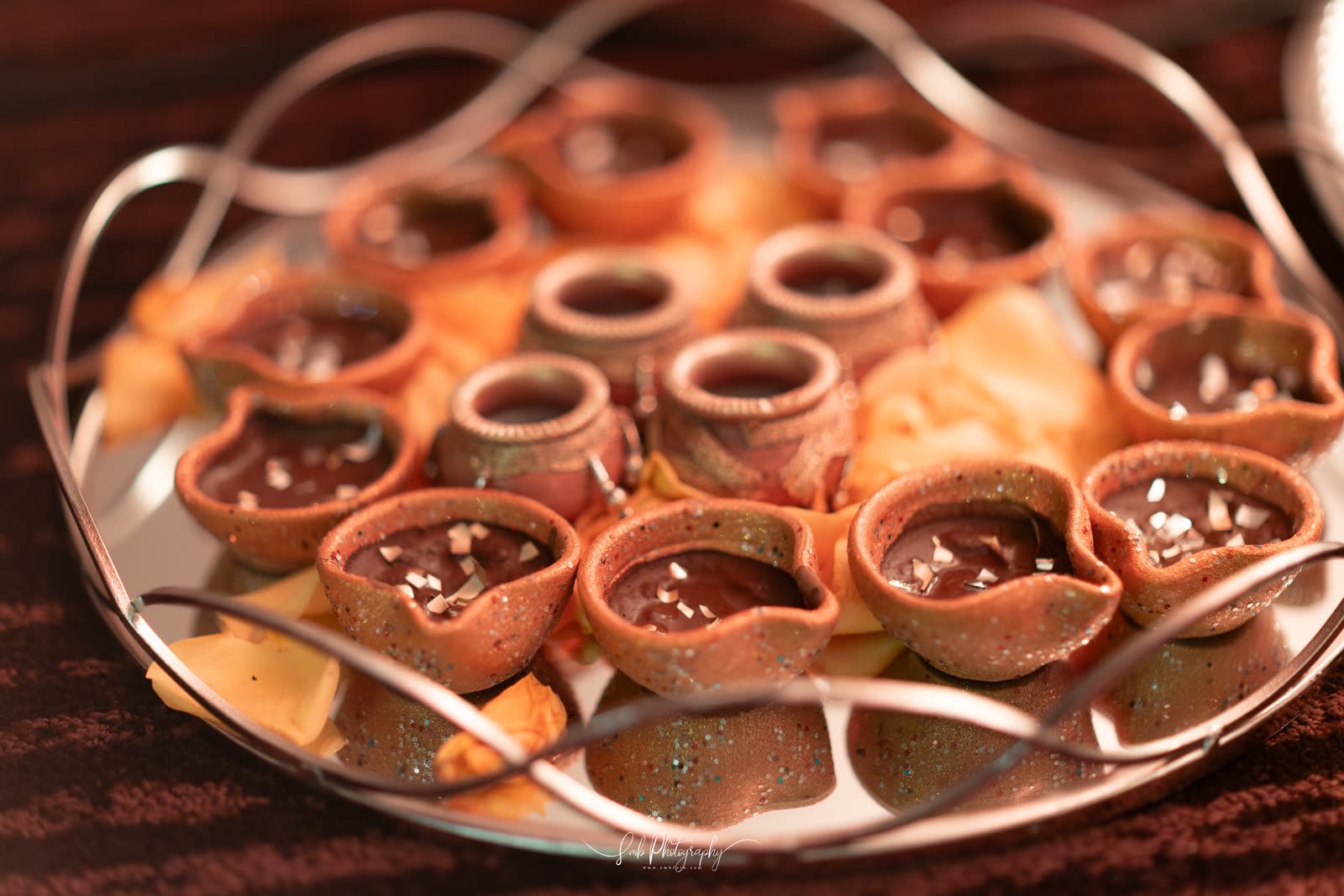 Chocolate cups on a mirrored tray