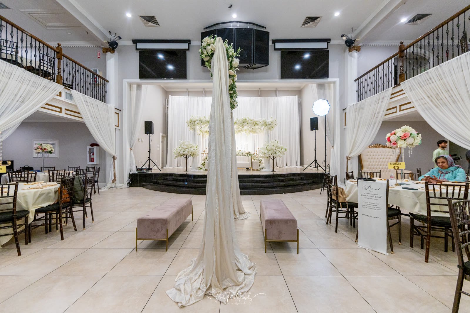 A draped ceremony backdrop in ivory