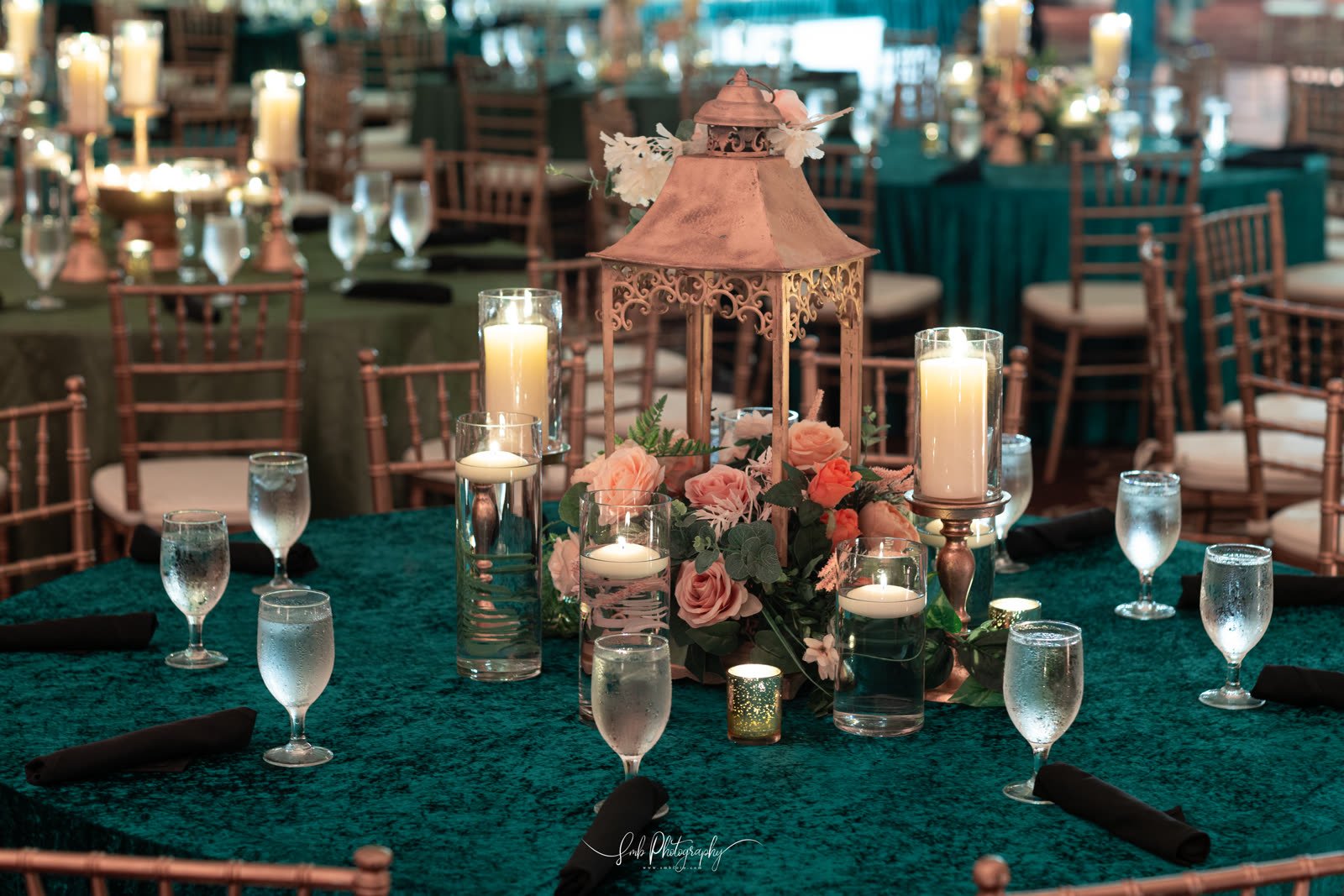 Candles and low florals down the centre of a dressed table