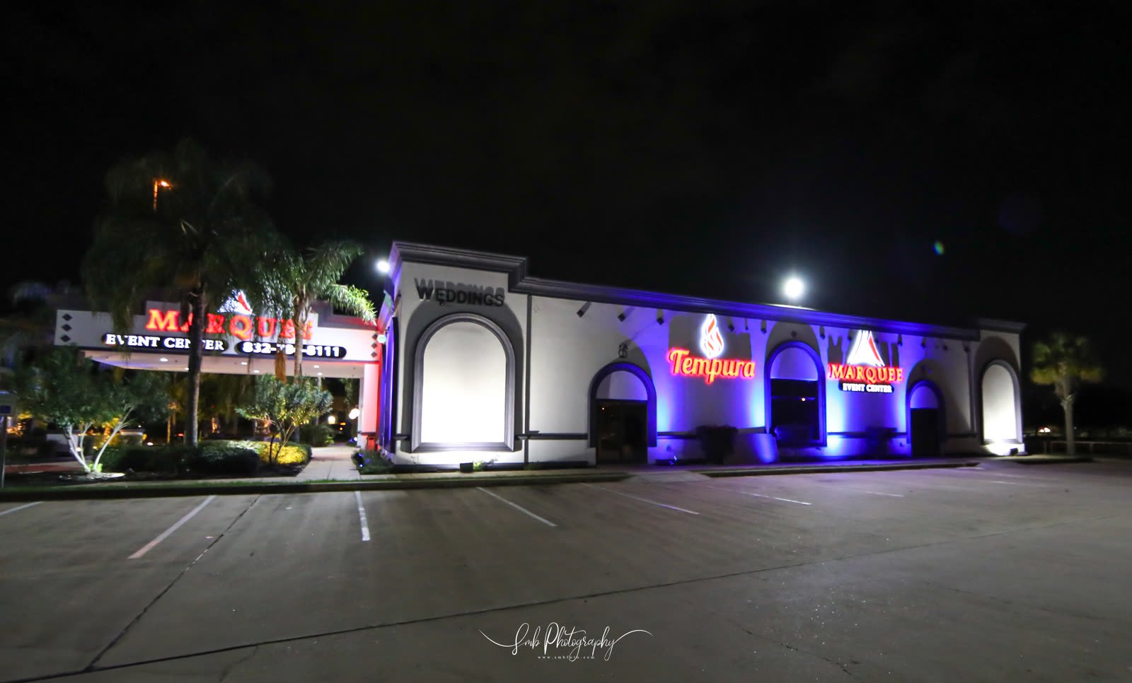 The venue lit in blue and violet after dark