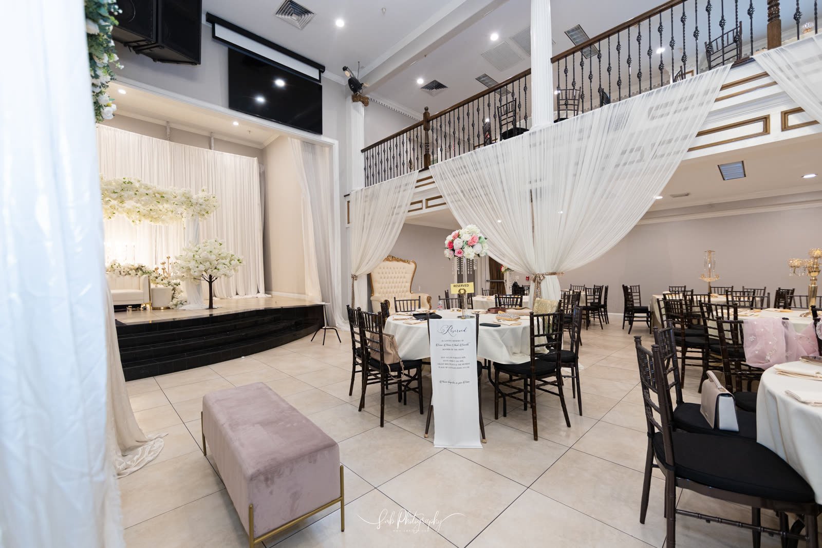 The ballroom in white, draped columns either side