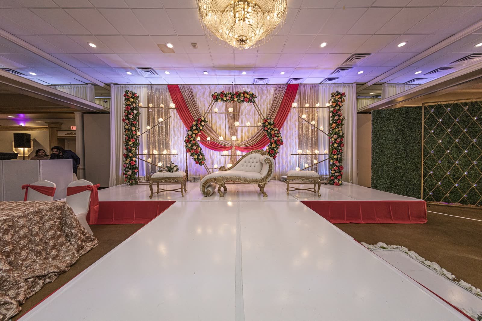 A draped mandap with a gold chaise