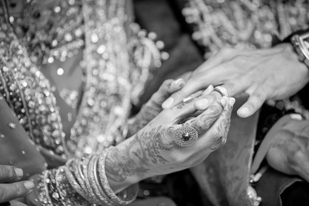 A bride's mehndi and rings, in black and white